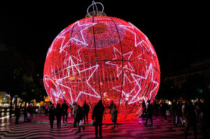 Lisbon, Portugal: People stand next to a giant Christmas ball